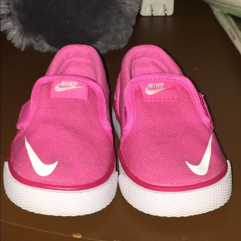 Toddler pink Nike slip on sneakers.